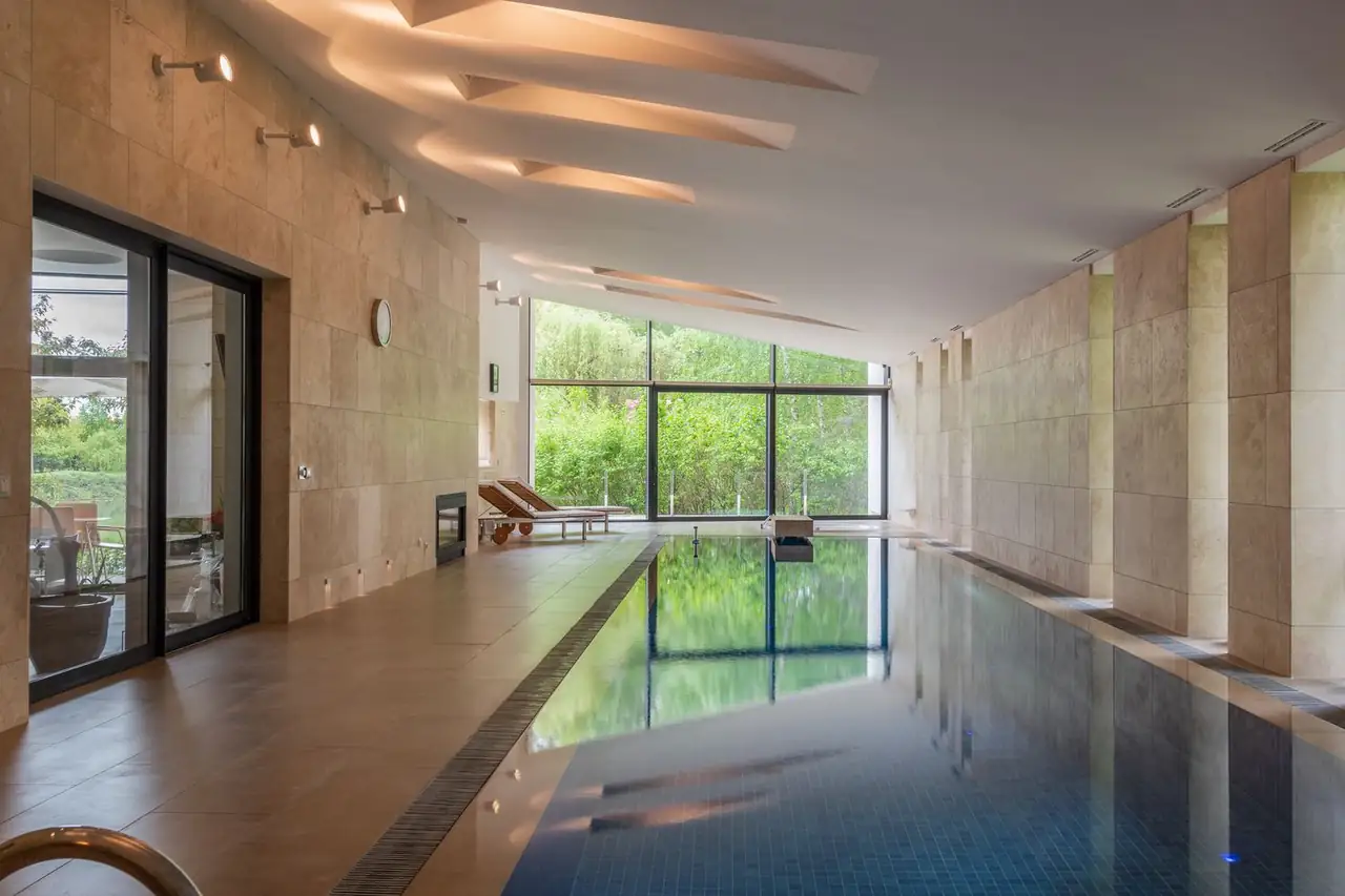 Illuminated indoor swimming pool with modern architecture