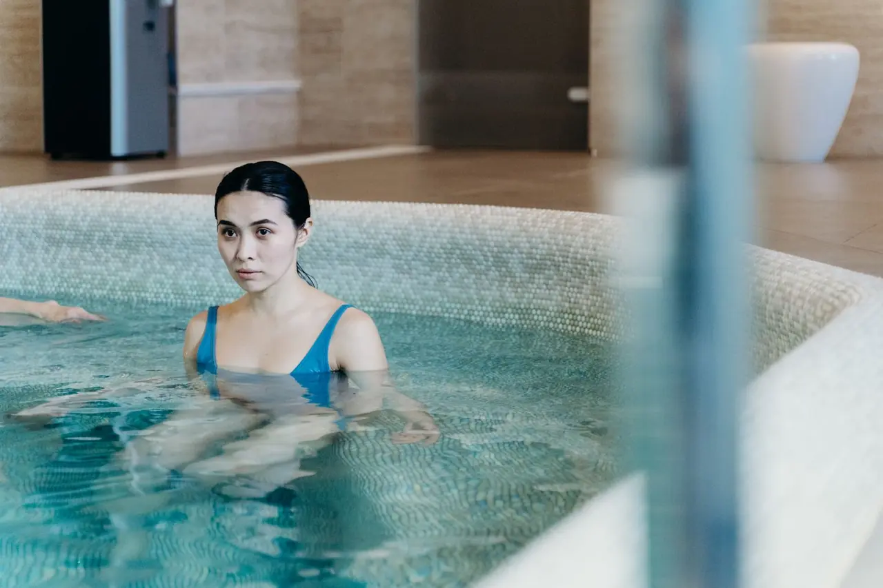 Calm wellness environment featuring indoor pool reflection