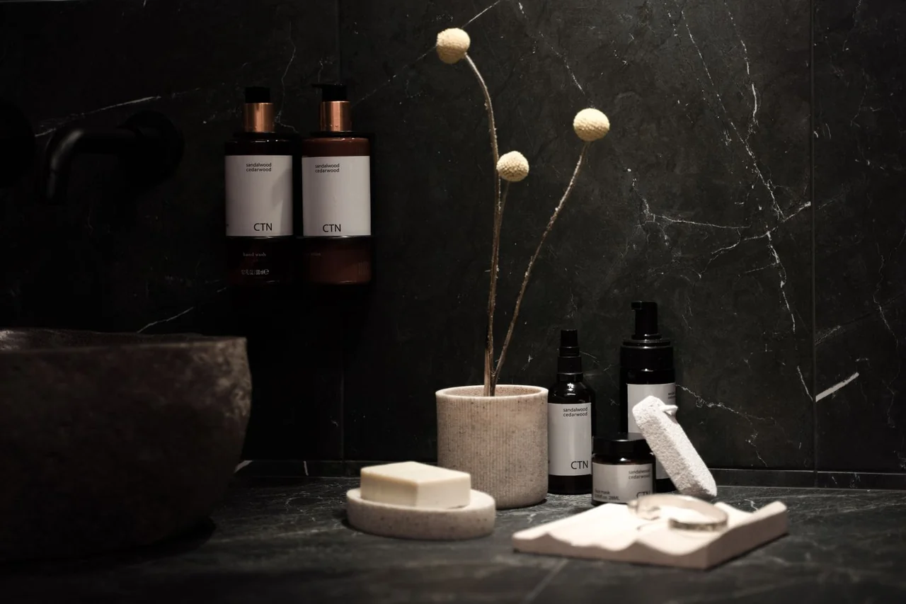 Curated skincare and wellness amenities on marble surface
