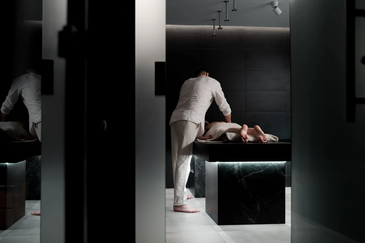Serene massage treatment room with ambient lighting